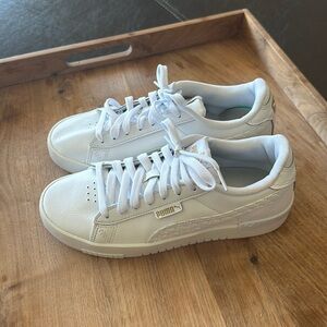 Bright white and puma sneakers. Little gold puma logo on the side. Wore it once